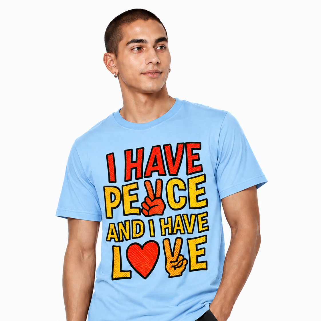 Male model wearing a pink graphic T-shirt featuring “I HAVE PEACE AND I HAVE LOVE” comic-style artwork